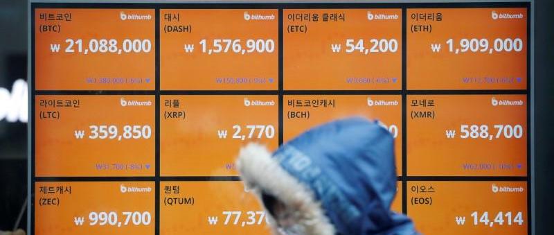 A man walks past an electric board showing exchange rates of various cryptocurrencies at Bithumb cryptocurrencies exchange in Seoul, South Korea, January 11, 2018. Photo: Reuters/Kim Hong-Ji